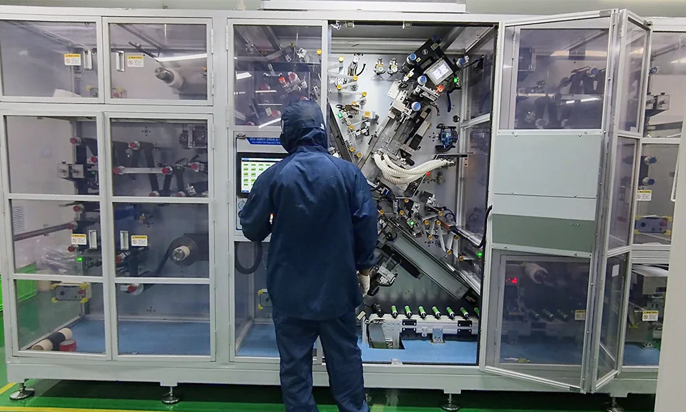 Commissioning a 32140 Tabless Cylindrical Cell Winding Machine TOB engineer commissioning a 32140 tabless cylindrical cell winding machine